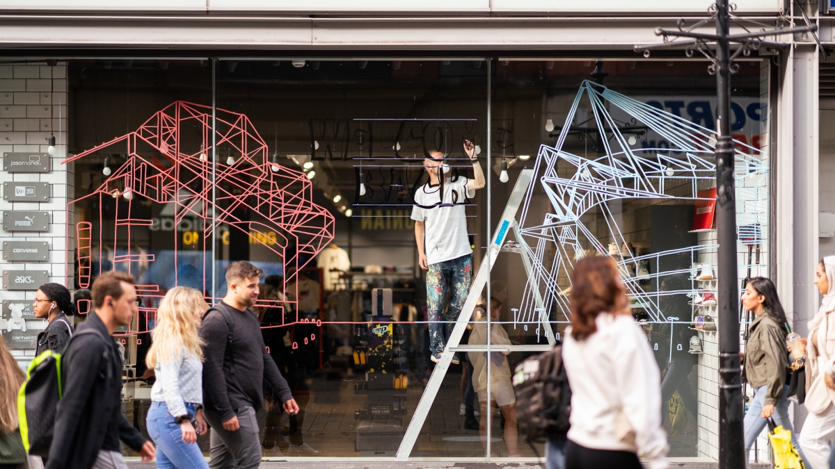 We invited Art of Football to decorate our size? Manchester shop front We invited Art of Football to decorate our size? Manchester shop front